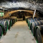 Explore an atmospheric wine cellar with oak barrels, set in the historical town of Cochem, Germany.